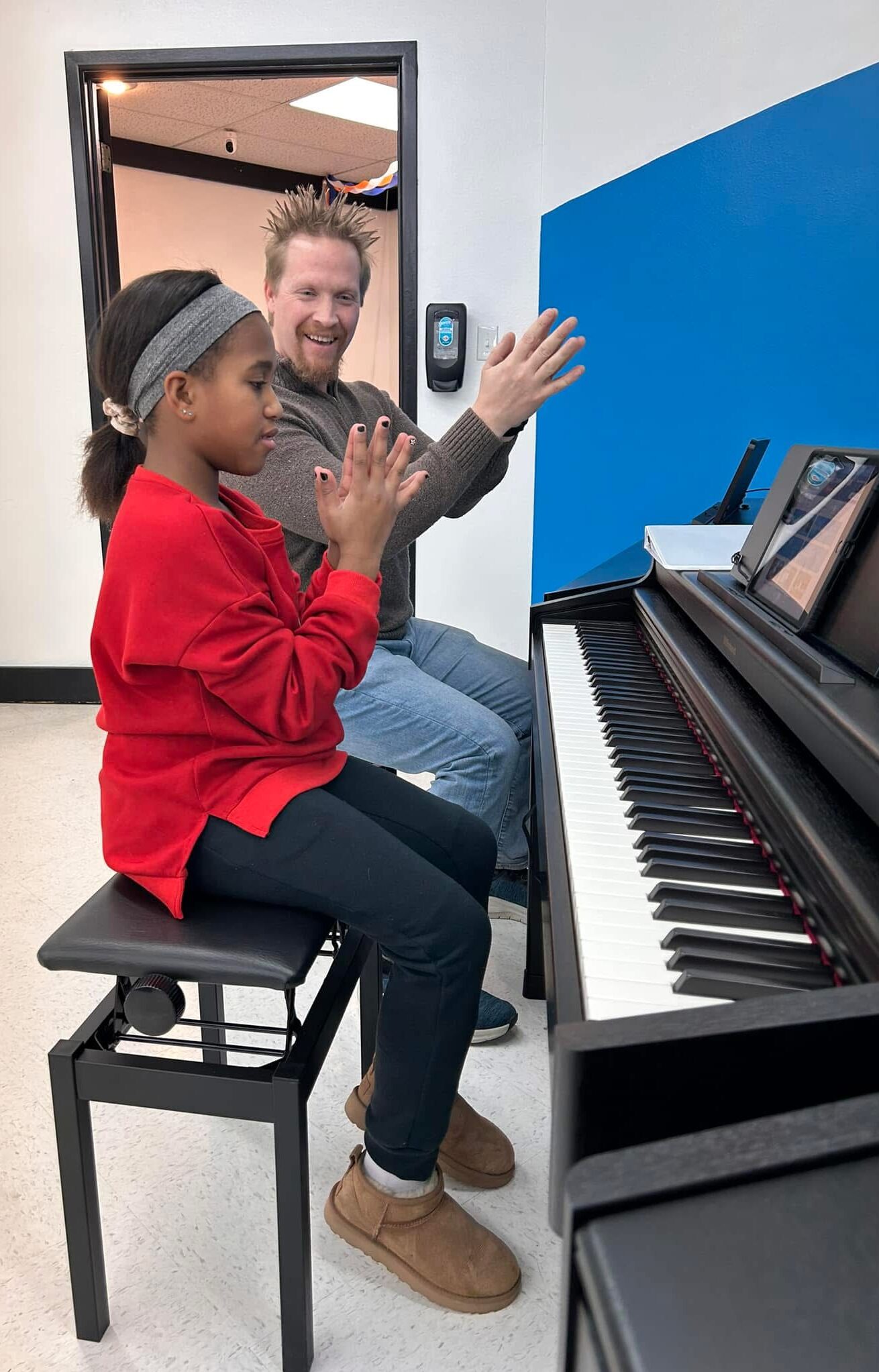 Copy of IMG_8044 (2) Piano Marvel Academy teacher leading student through off-bench hand coordination exercise with Piano Marvel software visible on screen
