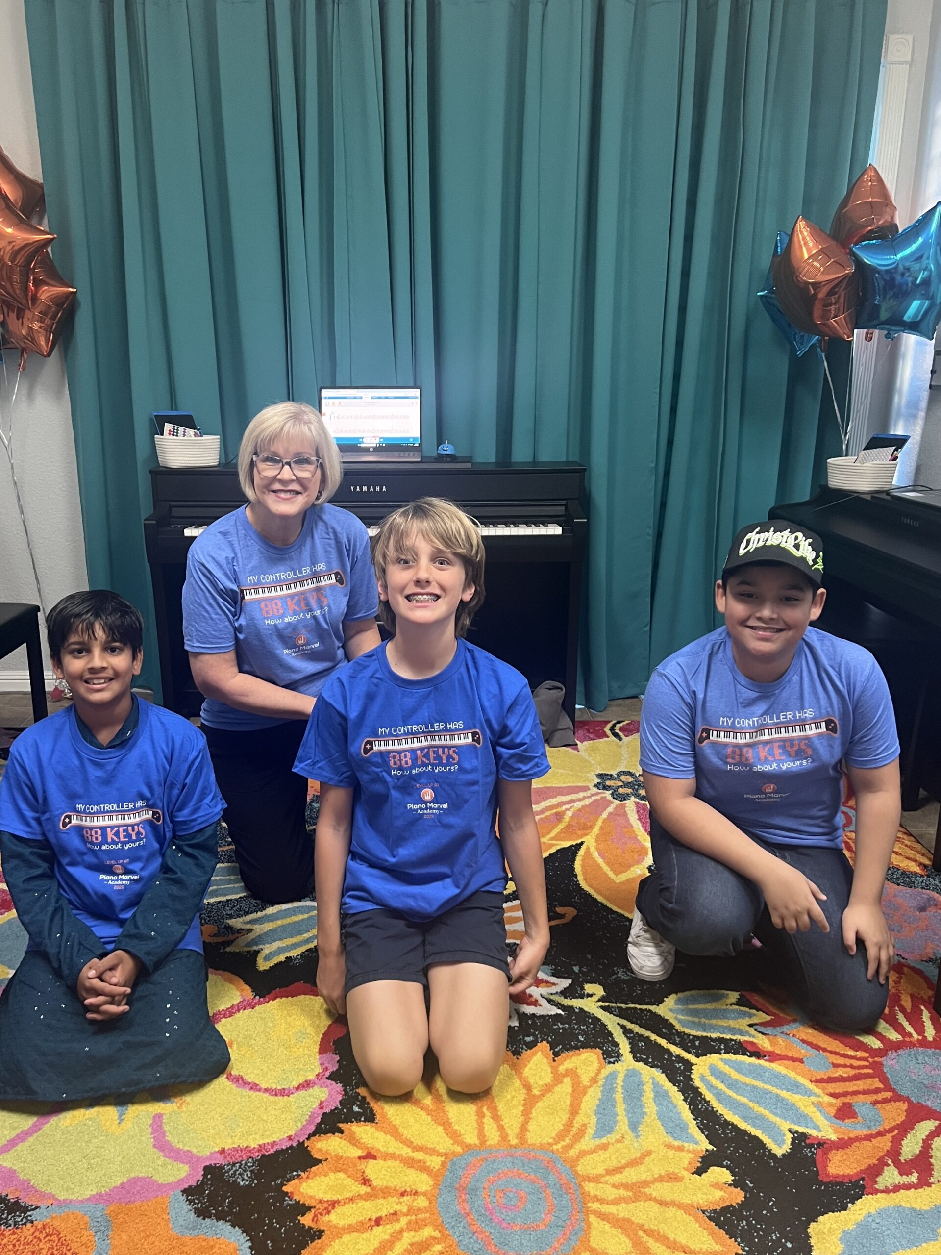 Piano Marvel Academy Modesto director Cindy White with students during a group piano lesson